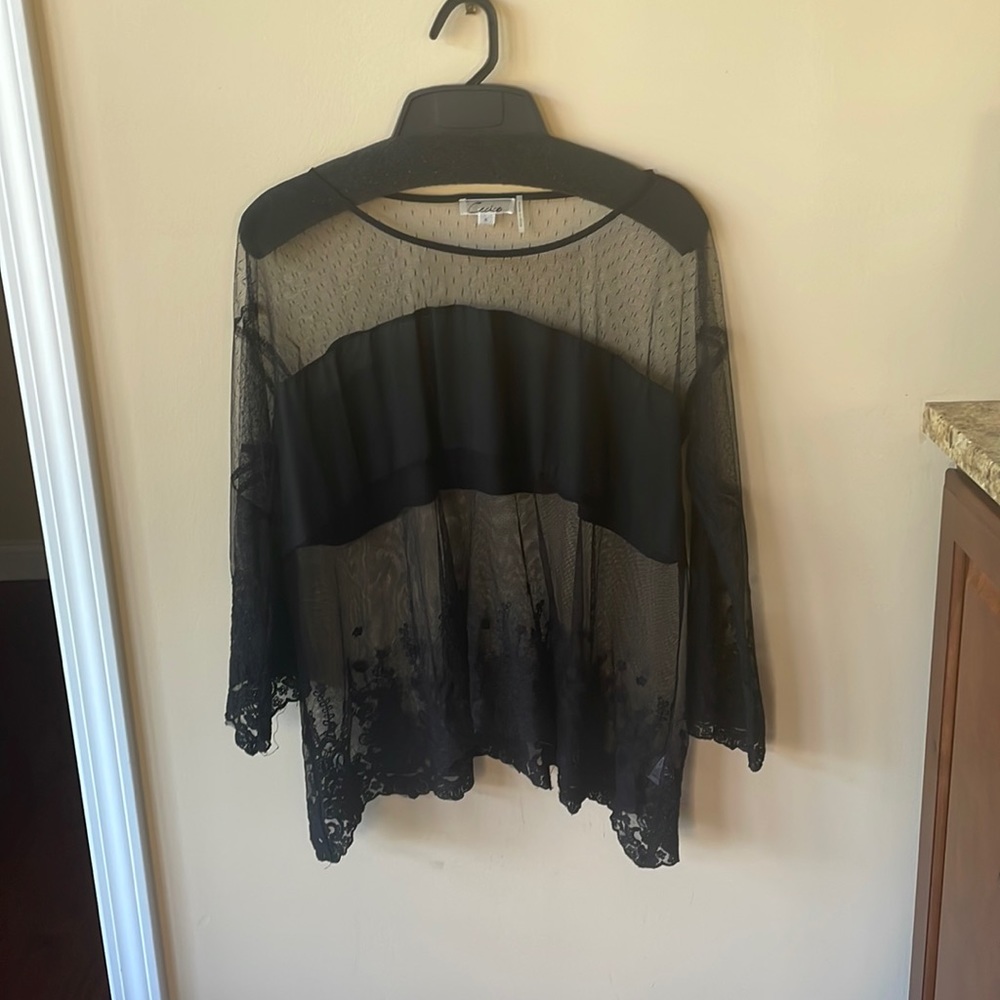 Woman’s black sheer top
